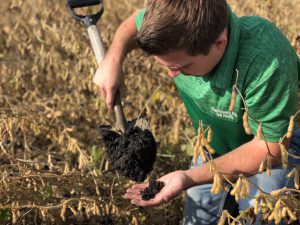Iowa Farmer Mitchell holding soil